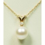 A 14K gold , 7mm cultured pearl and brilliant cut diamond set pendant, chain, 1.1gm