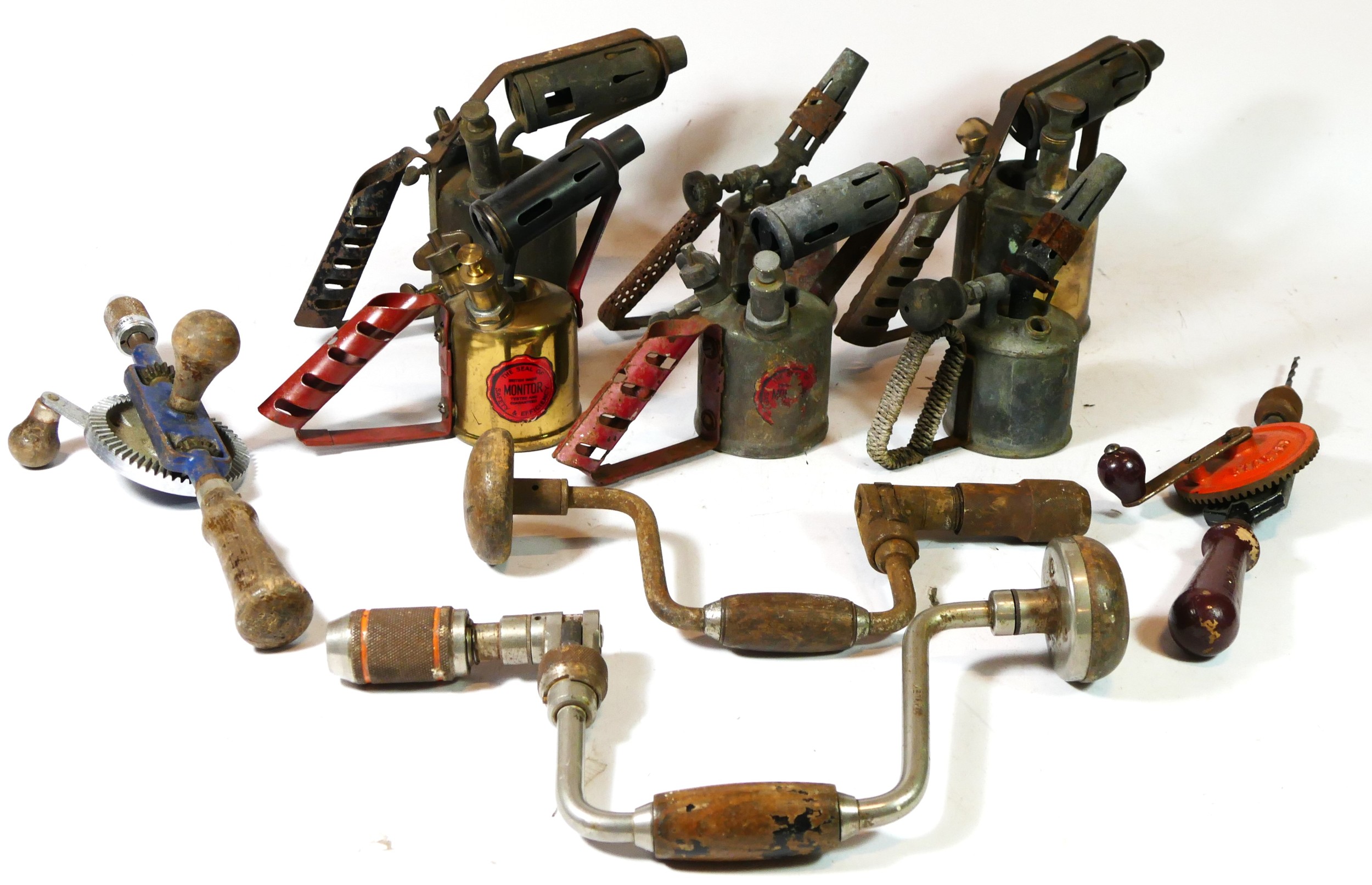 A collection of six early 20th century brass paraffin blow lamps.