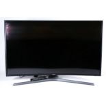 A Samsung 40 inch curved TV, model number UE40 JU67 40UXXU, with power lead and remote.