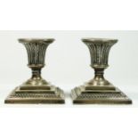 A Victorian silver pair of desk candlesticks, by Martin & Hall, Sheffield 1899, raised on square