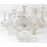 A collection of glassware to include cut glass and crystal glass drinks decanters.