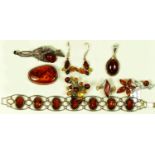 A silver mounted amber panel link bracelet, 16cm, a silver and amber star burst ring, another