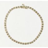 A 9ct gold line bracelet, set with 13 single cut diamonds, 18.5cm, 5.5gm