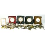 A collection of 1920s/30s traveling clocks, having 8 day movements, together with a quantity of