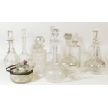 A collection of cut glass drink decanters, together with a quantity of glass stoppers.