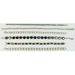 Two silver and opal set line bracelets, a silver and emerald line bracelet and three other silver