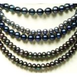 A 5mm bead black cultured pearl opera length necklace, 130cm and three other black pearl