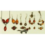 A silver set amber necklace, two pendants, four rings, and four pairs of ear rings, 34gm.