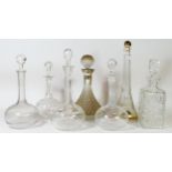 A ship’s drinks decanter, a hobnail cut decanter and five further crystal glass decanters.
