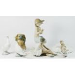A Lladro ceramic model of a dog, together with six Nao figurines. (7).