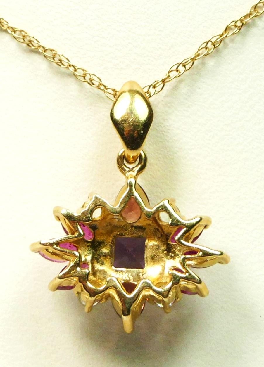 A 9ct gold gemset cluster pendant, set with ruby, garnet, amethyst and a clear stone, chain, 2.7gm - Image 2 of 2