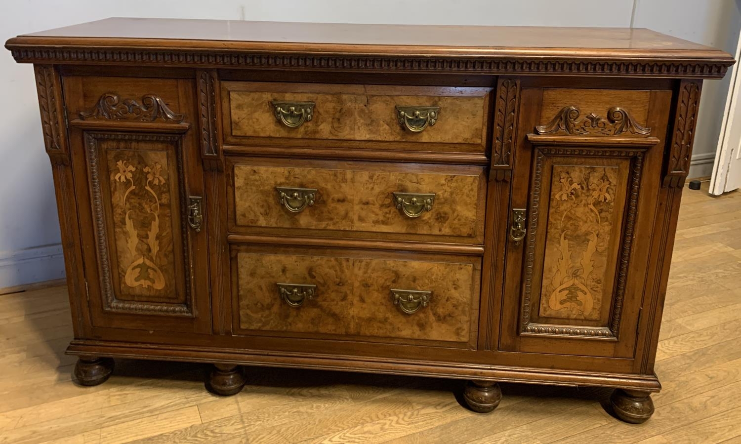 A early 20th century mahogany buffet, three central drawers flanked by two hinged doors, inlay