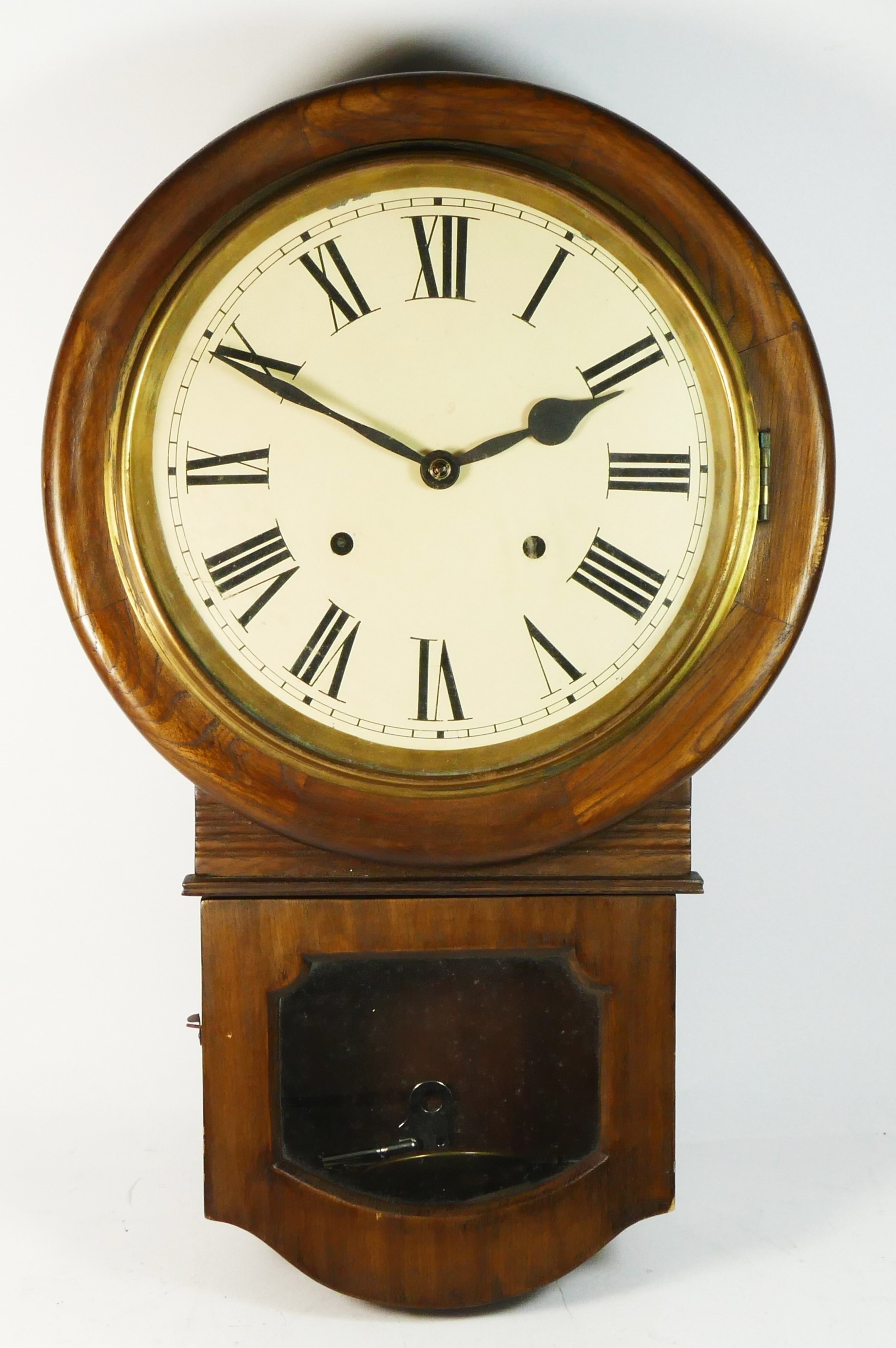 An oak cased drop dial wall clock, manual movement striking on gong, with pendulum and key. 53cm