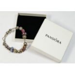 A silver Pandora bracelet, mounted with various charms, 61gm, box.