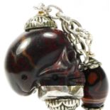 An early 19th century silver mounted, carved agate skull watch key, 43mm, to a chain with agate bead