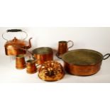 A square copper kettle, three graduated jugs , a saucepan, a pan and a jelly mould