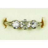 An 18ct white gold and old cut brilliant three stone diamond ring, claw set with graduated stones,