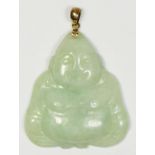 A carved jadeite pendant of a seated Buddha, gold mounted, 40 x 35mm