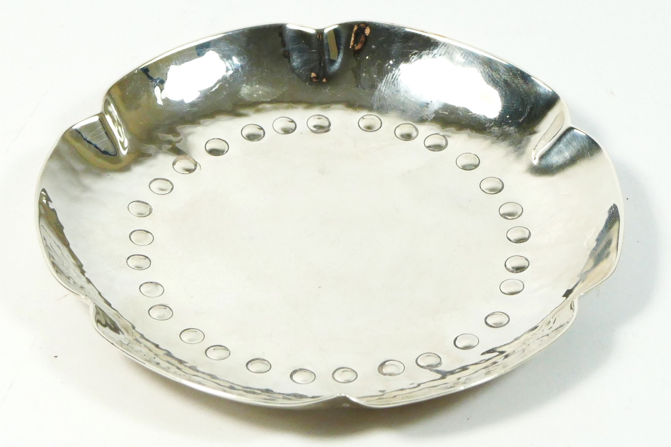 A silver Arts and Craft pin dish, by Arthur Duckworth, Chester 1946, of hammered finish, diameter
