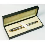 Cross, a gold plate and chrome fountain pen, with Egyptian motifs, screw filler, unused, case.