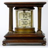 A mahogany and brass 'Ticket' desk clock, of cylindrical form, housed by four reeded brass pillars