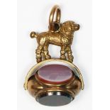 An Edwardian rose gold cased triple swivel fob, with French poodle surmount to cornelian, banded