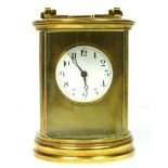 An Edwardian French brass circular carriage time piece, with white enamel dial, diameter 8.5cm,