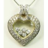 A 14K white gold and diamond heart shape pendant, stamped 585, in the style of Chopard Happy