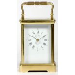 A French brass carriage clock, of rectangular form, the enamelled dial with Roman numerals and