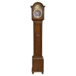 A mid 20th century oak cased grandmother clock, having silvered dial bearing Roman numerals, with