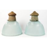 A pair of mid 20th century holophane prismatic glass pendant ceiling lights, with metal gal