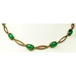 An Art Deco 9ct rose gold and stained green chrysoprase necklace, composed of ten cabochon stones, 9