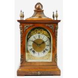 A Victorian mahogany and burr walnut German bracket clock, the bell-top case above four urn