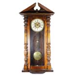 A late 19th century walnut Vienna style wall clock, the movement striking on a gong, pendulum,