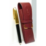 Cartier, a black lacquer and gold plated Dandy fountain pen, the ribbed cap and nib holder, signed