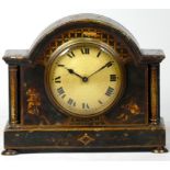 An early 20th century arched mantel clock, gilt brass dial with roman numerals, in a gilded black