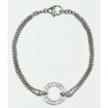 A white gold and diamond bracelet, tested 18ct, the hoop set with 14 brilliant cut stones, total