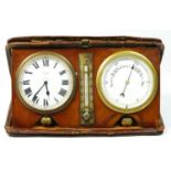 An Edwardian travelling desk set, comprising an eight day clock, the white enamel dial with