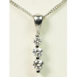 An 18ct white gold and graduated brilliant cut diamond pendant, unmarked, approximately 0.30cts,