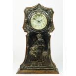 An Edwardian silver and oak mantle time piece, Birmingham 1905, the front with an embossed panel