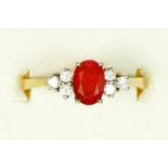 A 9ct gold, fire opal and brilliant cut diamond set dress ring, London 1987, M 1/2, 2.1gm