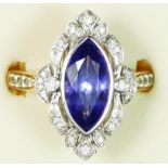 An 18ct gold tanzanite and diamond panel ring, collet set with a navette cut stone, 15 x 7mm,