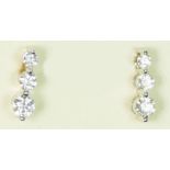 A pair of 18ct white gold and graduated brilliant cut diamond set ear studs, approximately 0.60cts