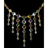 An 18ct gold spectacle set multi-gemstone necklace, stamped 750, collet set with aquamarine,