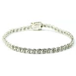 A 9ct white gold and brilliant cut diamond line bracelet, stated weight 0.25cts, 18cm, 7.5gm