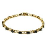 A 9ct gold, sapphire and diamond panel link bracelet, 19.5cm, 7.8gm.