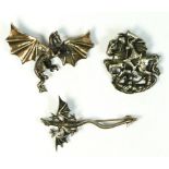 A 800 standard silver St. George and the Dragon brooch and two silver dragon brooches, 32gm