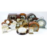 A collection of manual wind and quartz clocks, to include traveling alarm clocks and miniature