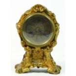 A George II style miniature gilt metal mantel clock, cartouche shape case, silvered dial with engine
