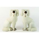 A pair of large mid 19th century English Staffordshire porcelain seated poodle dogs, of typical form